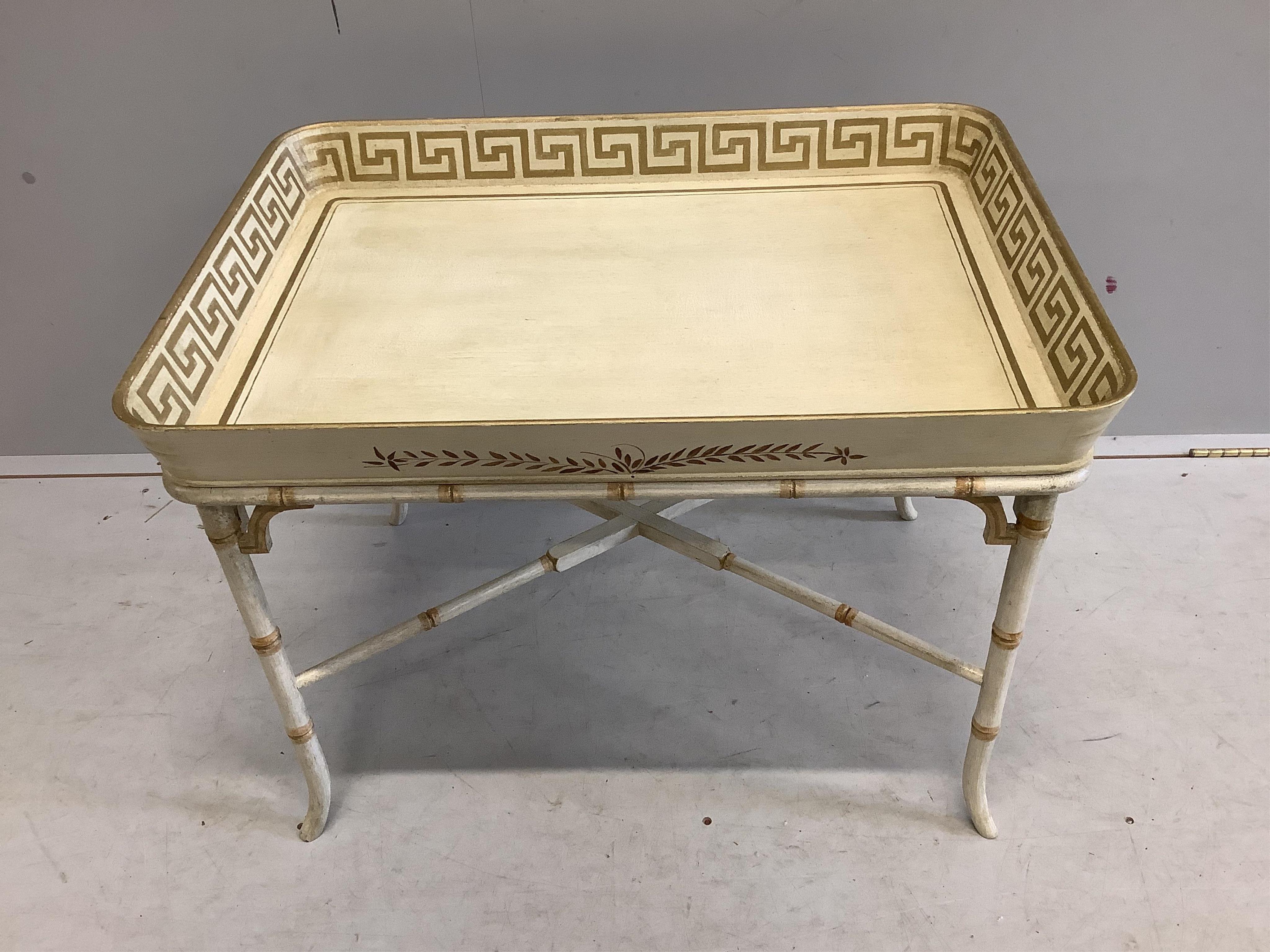 A Regency style rectangular cream painted tray top table, with faux bamboo stand, width 77cm, depth 55cm, height 58cm. Condition - good